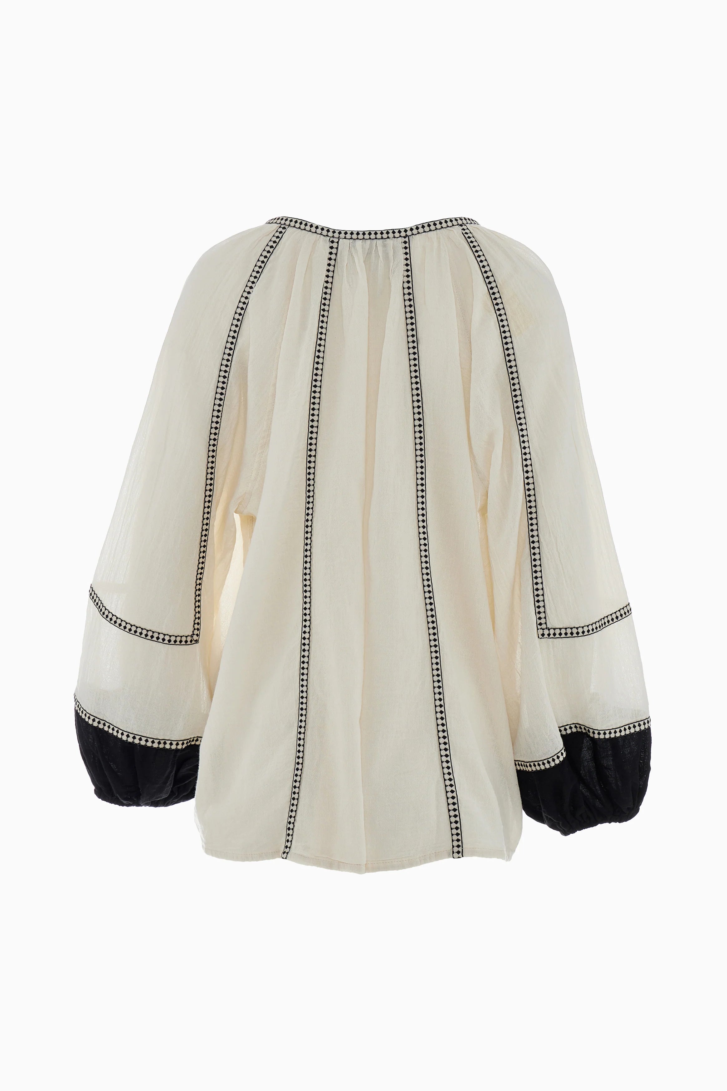 White blouse with black trim on a white background