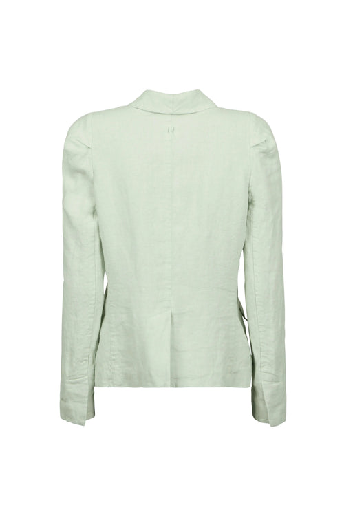 A light sage green linen jacket by Hannes Roether label shown from the back, featuring a high folded collar, long sleeves, and subtle shoulder detailing, displayed against a solid pale blue-gray background.