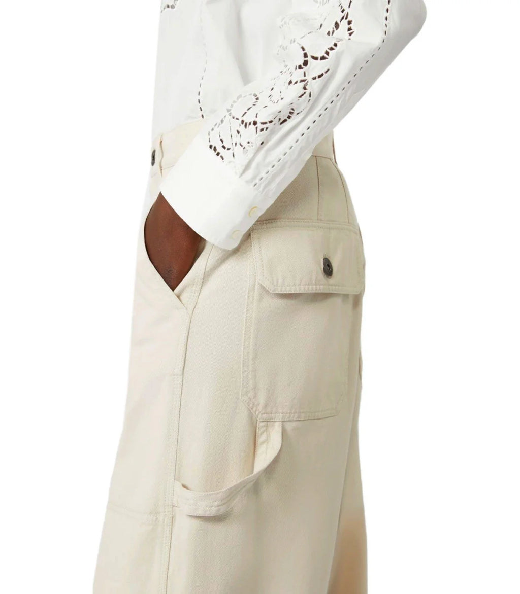 Beige pants with a white lace top on a white background