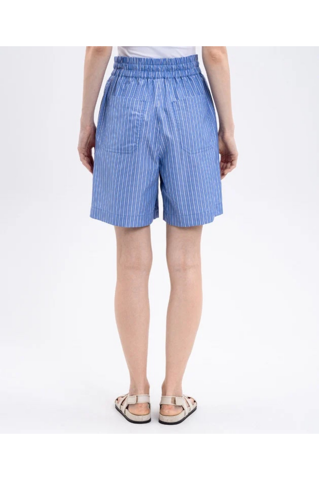 Person wearing blue striped shorts on a white background
