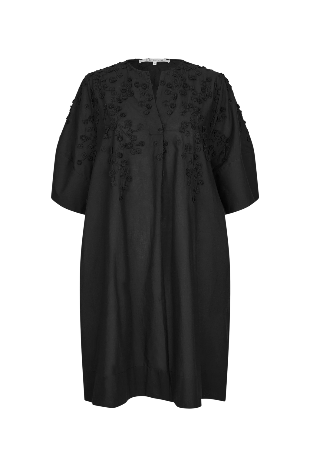 A black short-sleeved tunic dress with intricate floral embroidery and applique detailing on the chest and shoulders, displayed against a solid white background.