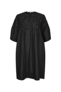 A black short-sleeved tunic dress with intricate floral embroidery and applique detailing on the chest and shoulders, displayed against a solid white background.