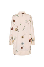 A long-sleeve button-up shirt in a light cream or pale beige color, decorated with a scattered floral print in muted shades of brown, green, and light blue, shown against a plain white background.