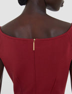 Red dress with a gold zipper on a plain background