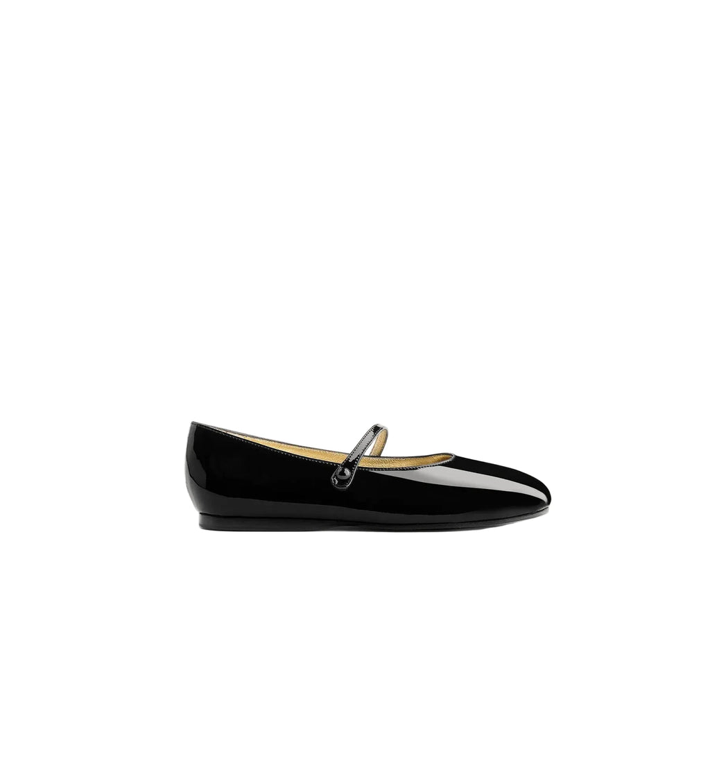 Black patent leather flat shoe with a strap on a white background