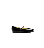 Black patent leather flat shoe with a strap on a white background