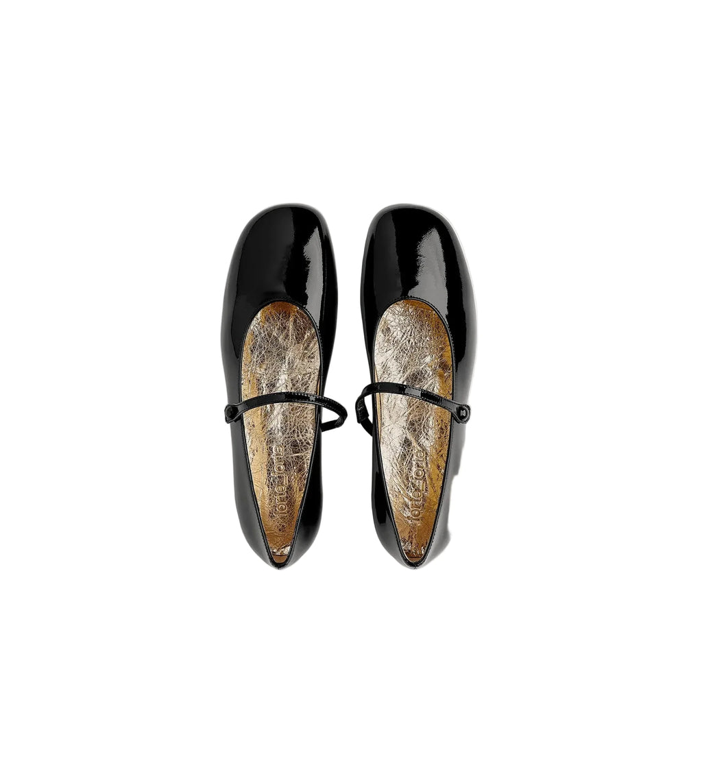 Pair of black patent leather shoes with a white background