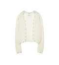 An off-white textured knit cardigan with green dotted trim along the edges, displayed flat against a light gray background.