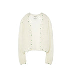 An off-white textured knit cardigan with green dotted trim along the edges, displayed flat against a light gray background.