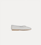 Silver woven flat shoe on a light gray background