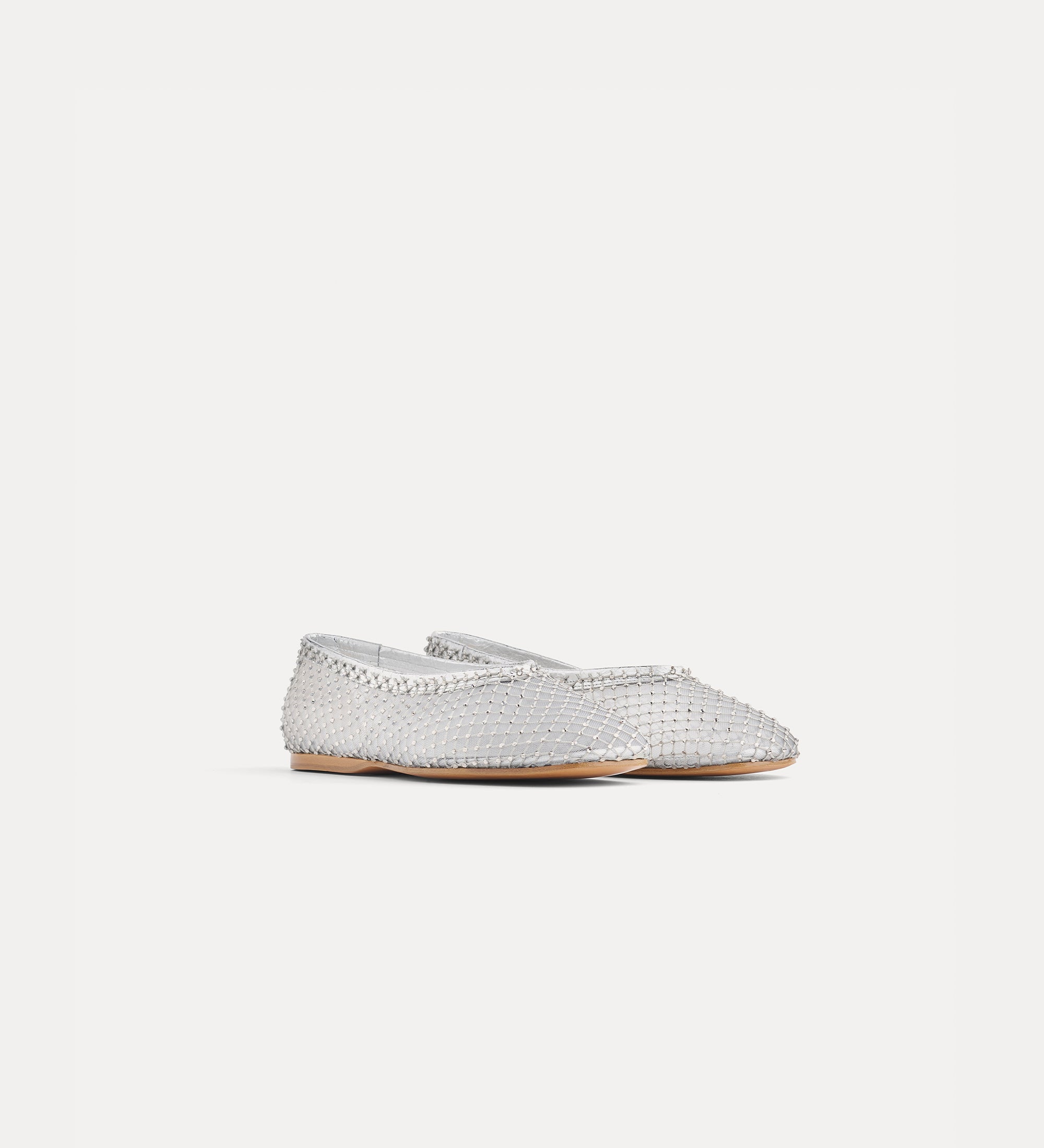 Silver flat shoe on a light gray background