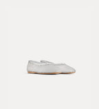 Silver flat shoe on a light gray background