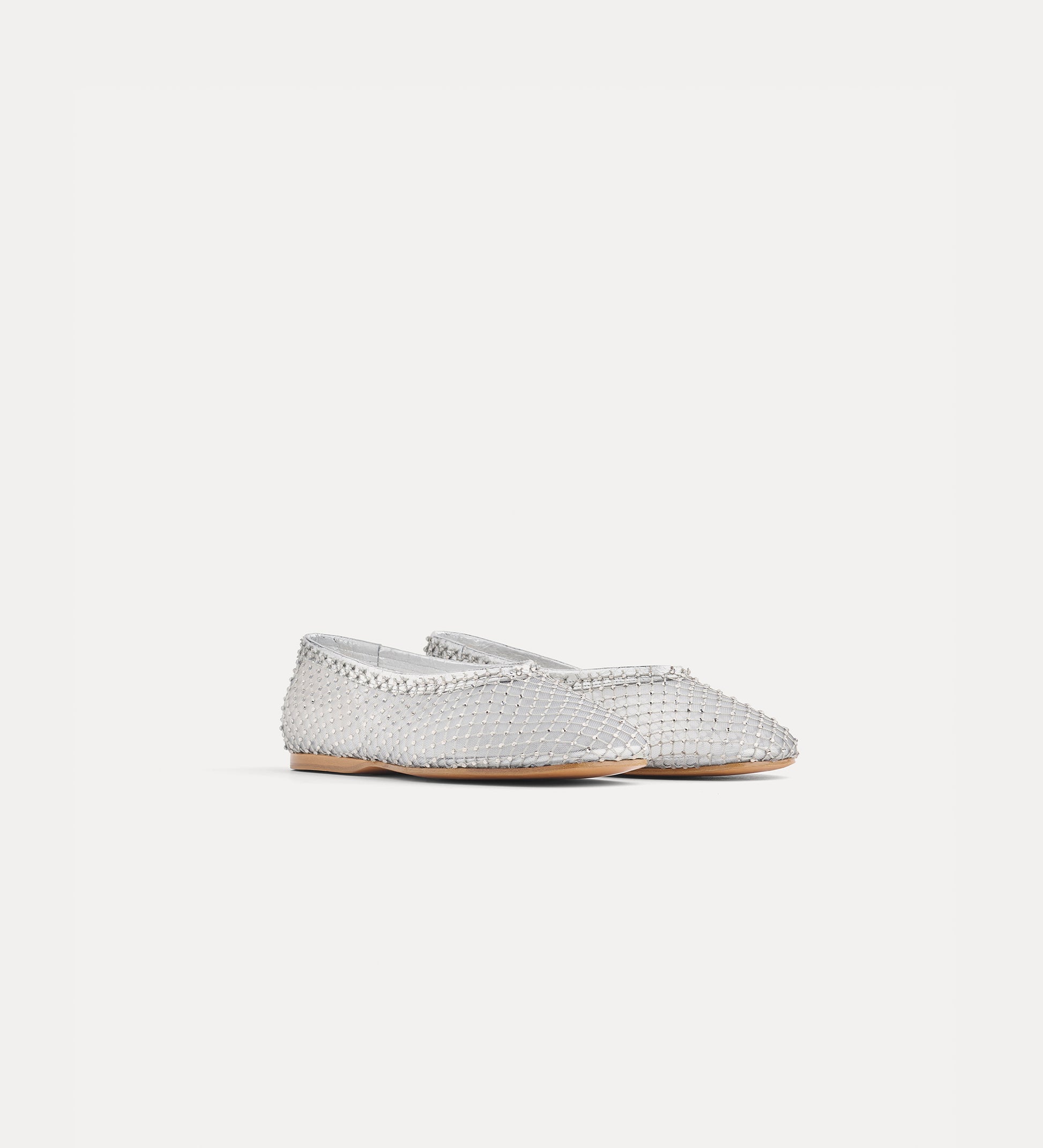 Silver flat shoe on a light gray background