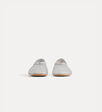 Pair of silver glittery shoes on a white background