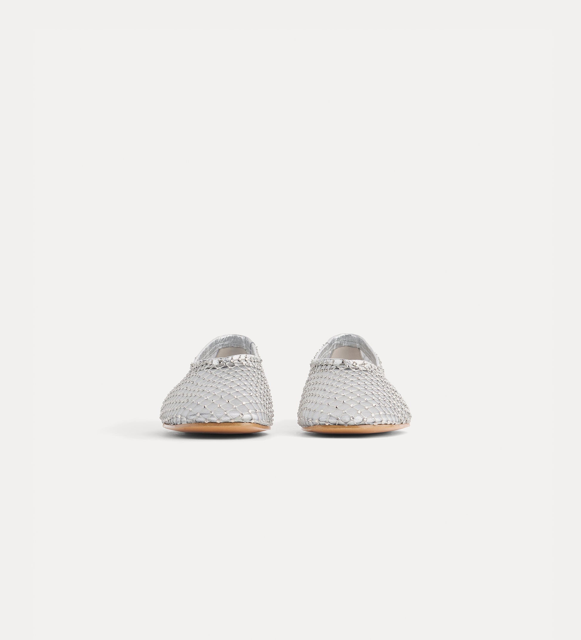 Pair of silver glittery shoes on a white background