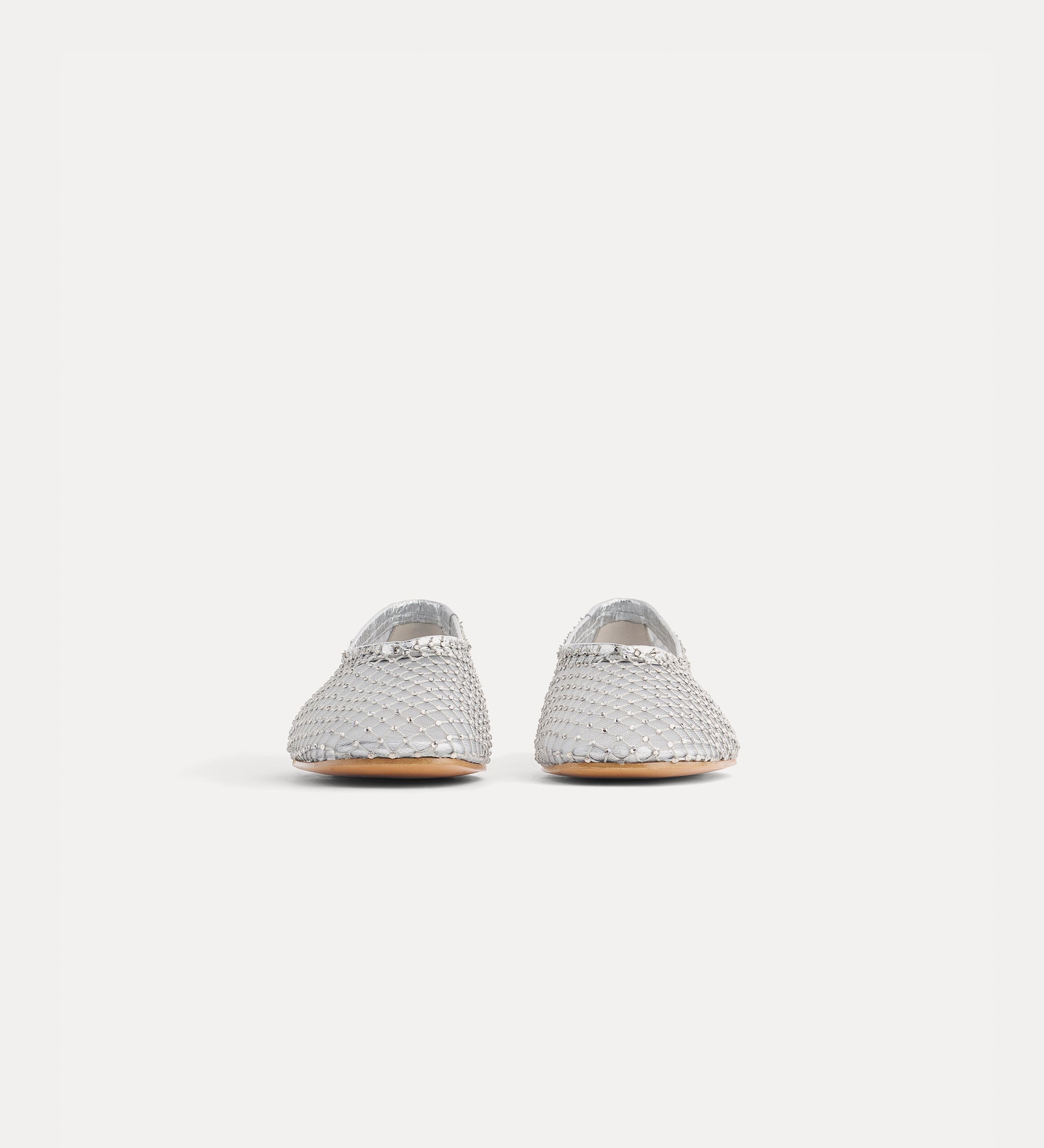 Pair of silver glittery shoes on a white background