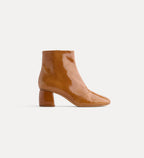 Tan ankle boot on a white background