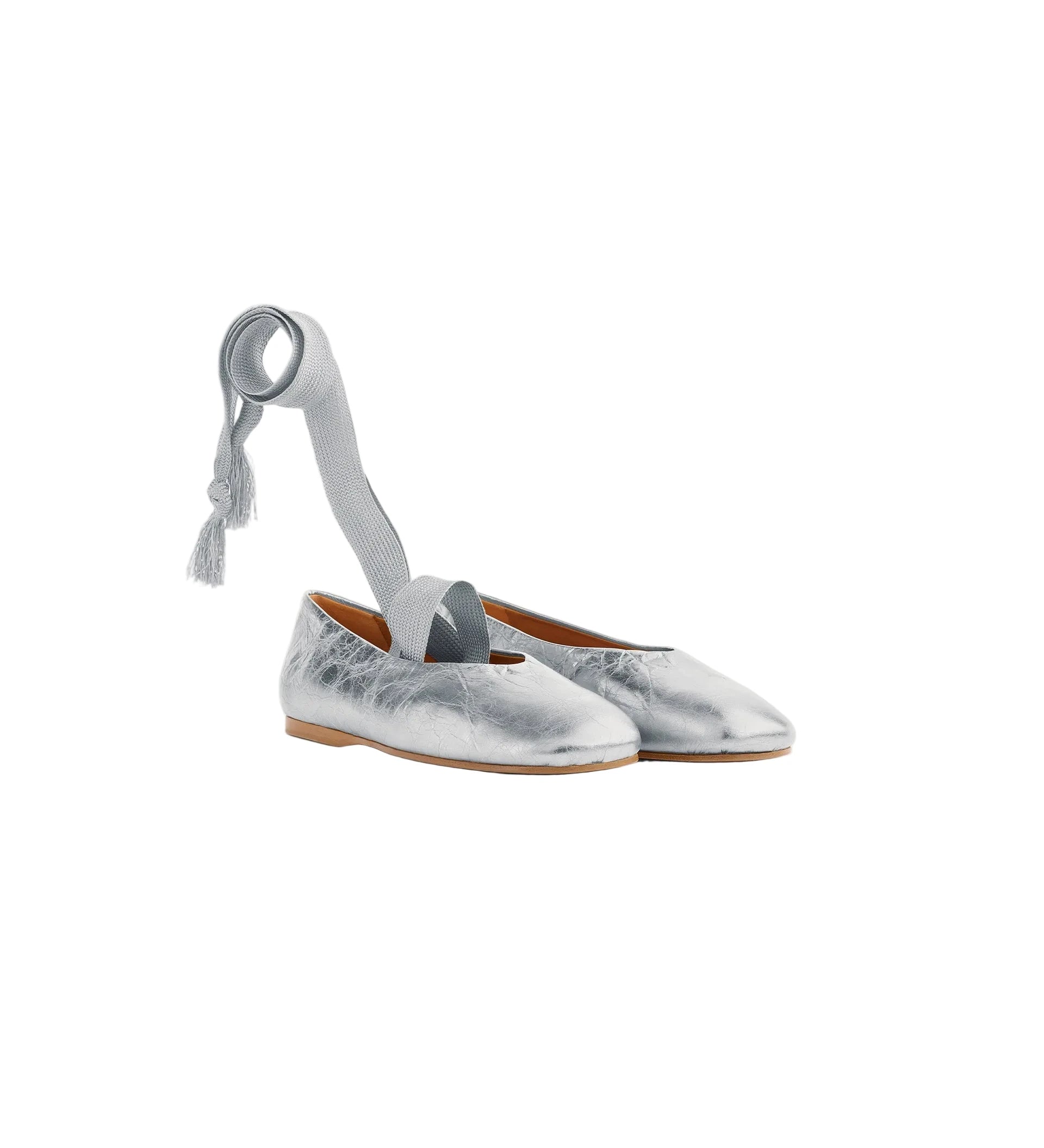 Silver metallic shoes with a ribbon on a white background