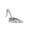 Silver metallic shoes with a ribbon on a white background