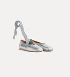 Silver metallic shoes with a ribbon on a white background