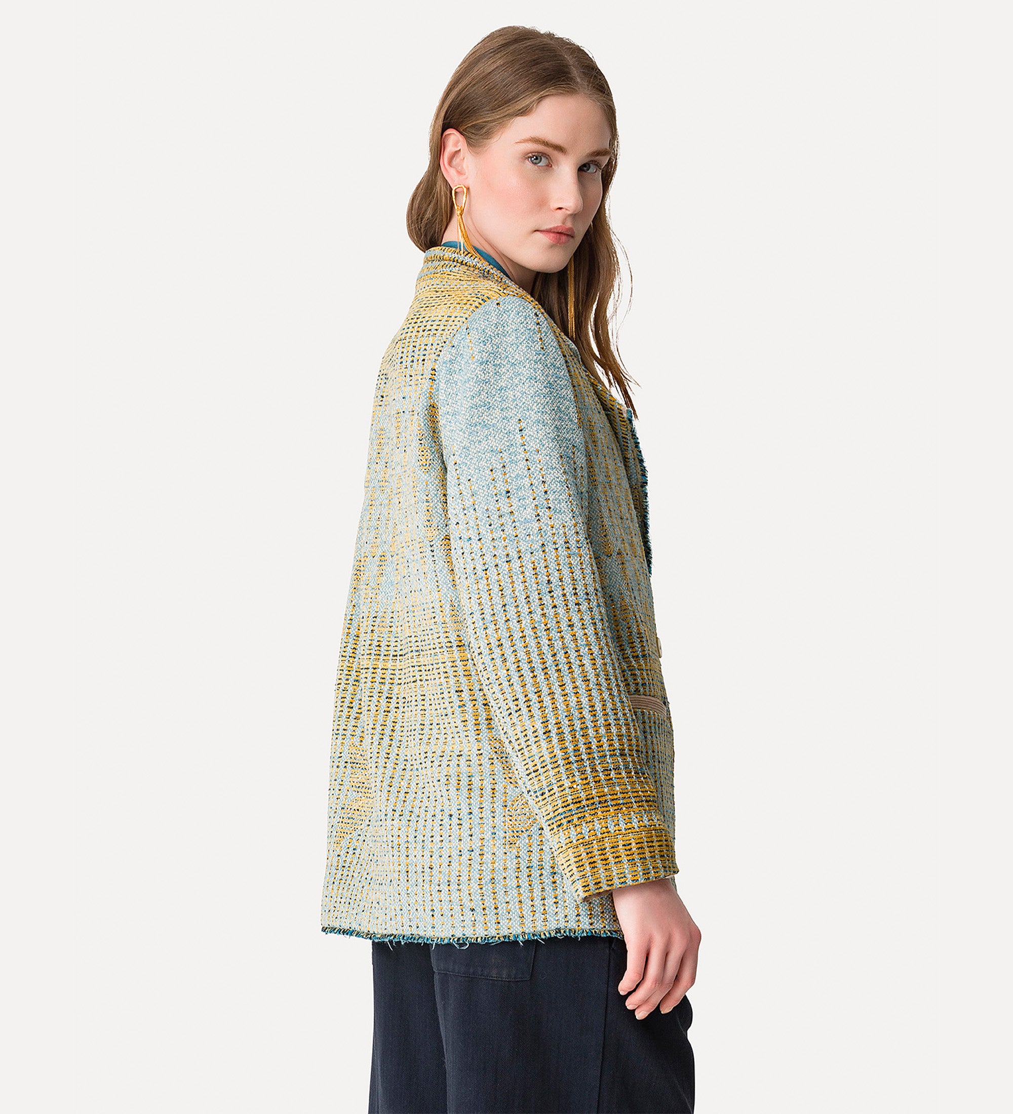 Woman wearing a textured jacket with a white background