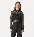 Woman wearing a black and sheer blouse with a white background
