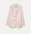 Pink blazer with black buttons on a light gray background