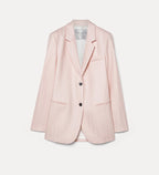 Pink blazer with black buttons on a light gray background