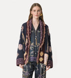 Woman wearing a patterned cardigan with a white background