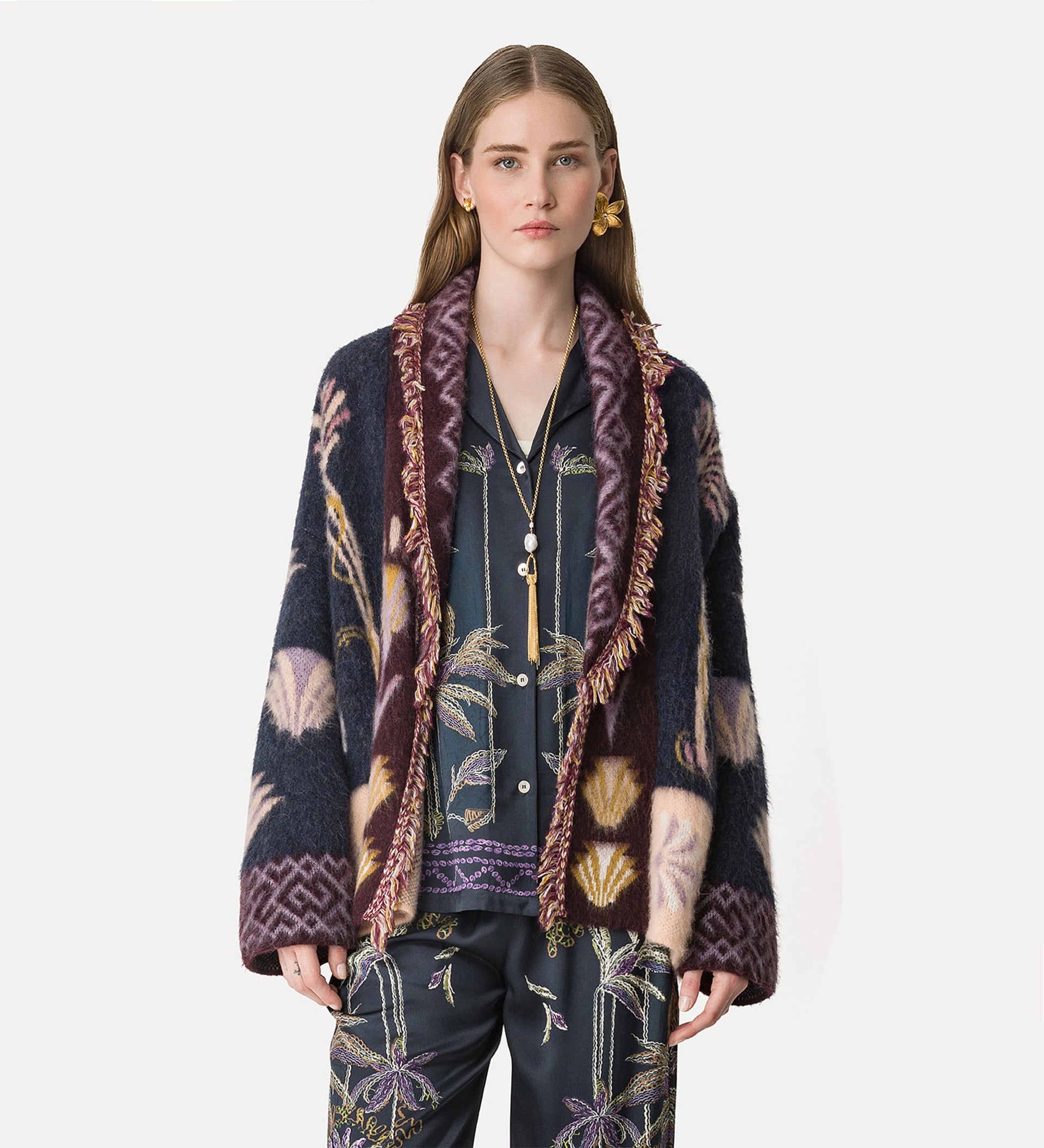 Woman wearing a patterned cardigan with a white background