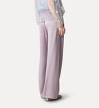 Person wearing light purple wide-leg pants on a white background