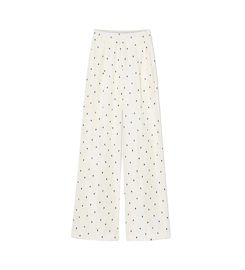 White pants with black polka dots on a white background