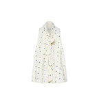 White shirt with black polka dot pattern on a white background