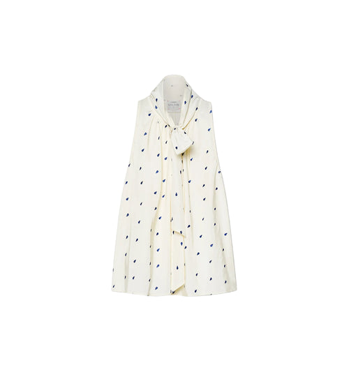 White shirt with black polka dot pattern on a white background