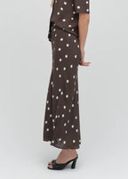 Brown dress with white polka dots on a white background