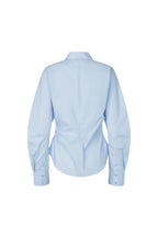 A light blue long-sleeve button-up shirt shown from the back, featuring a pointed collar and a gathered waist design, displayed on a solid white background.