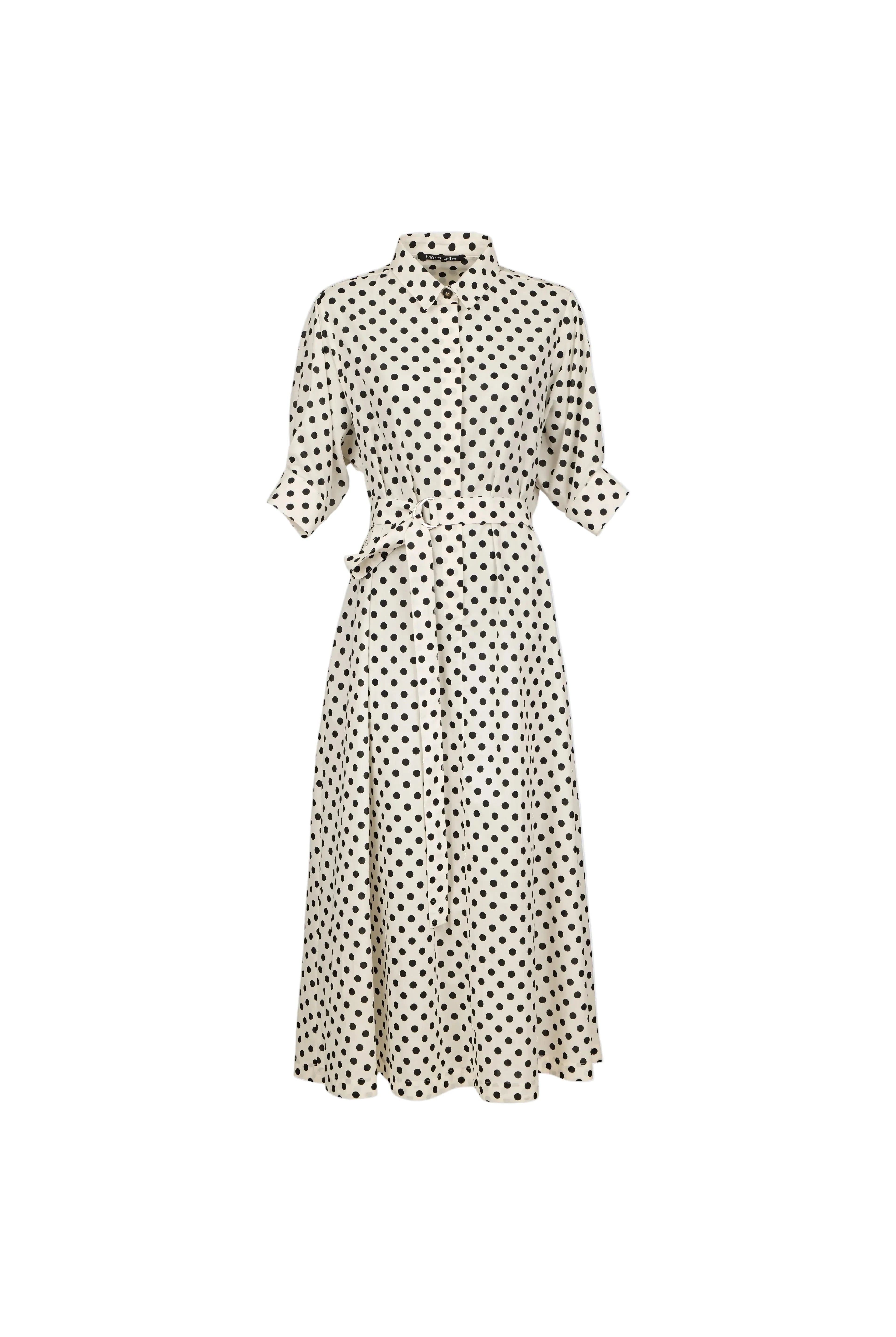 A cream-colored midi dress with a black polka dot pattern, featuring a collar, button-up front, and a matching fabric tie belt at the waist, shown against a solid light blue background.
bet28ter-k.4061
Hannes Roether