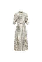 A cream-colored midi dress with a black polka dot pattern, featuring a collar, button-up front, and a matching fabric tie belt at the waist, shown against a solid light blue background.
bet28ter-k.4061
Hannes Roether