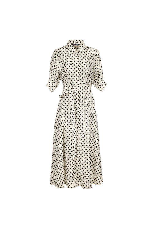 A cream-colored midi dress with a black polka dot pattern, featuring a collar, button-up front, and a matching fabric tie belt at the waist, shown against a solid light blue background.
bet28ter-k.4061
Hannes Roether
