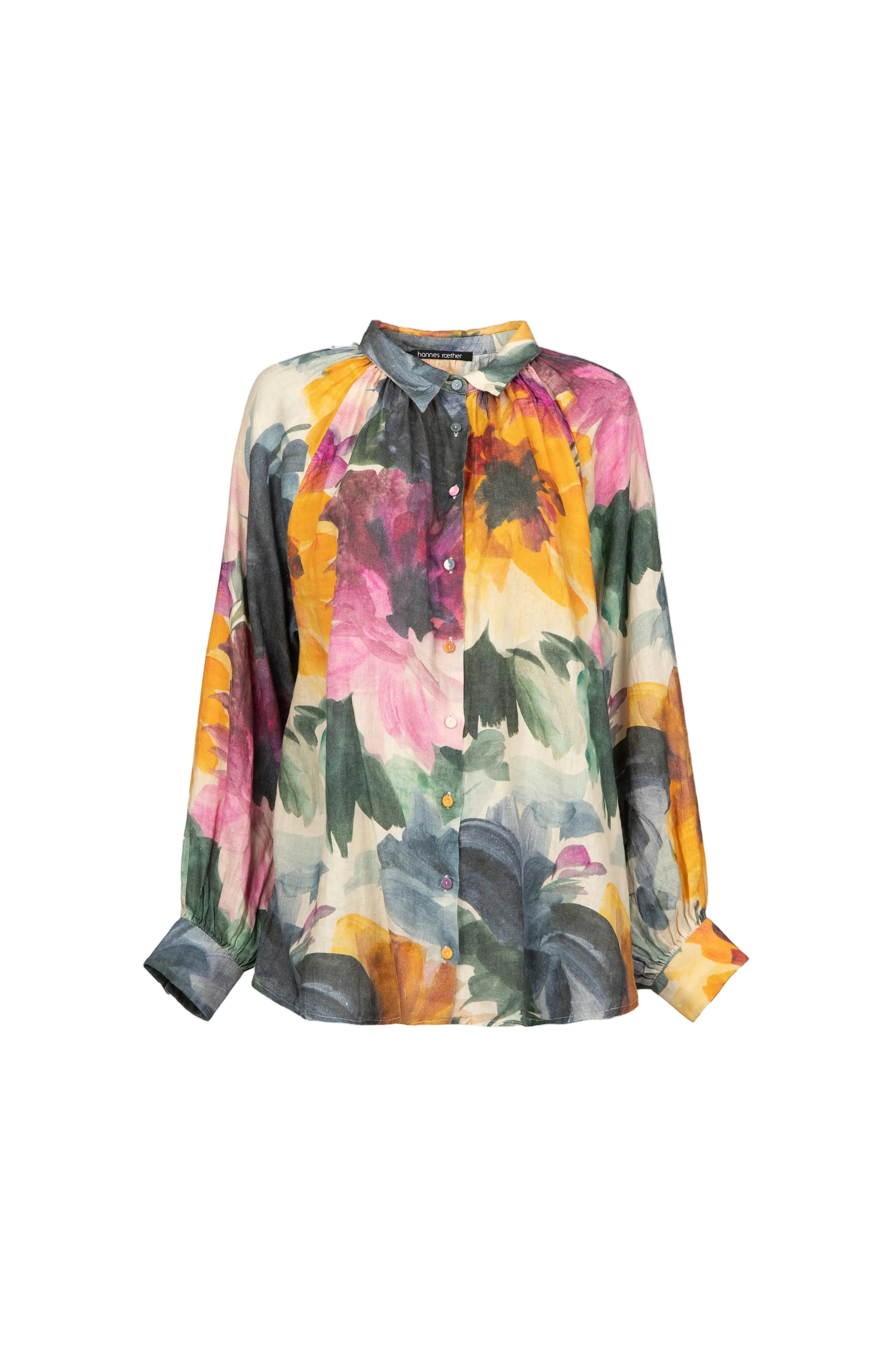 A long-sleeve blouse with a vibrant watercolor floral print in pink, yellow, orange, green, and blue on a cream base, featuring a tie-neck detail, shown against a light gray background.
de29ar.4056
Hannes Roether