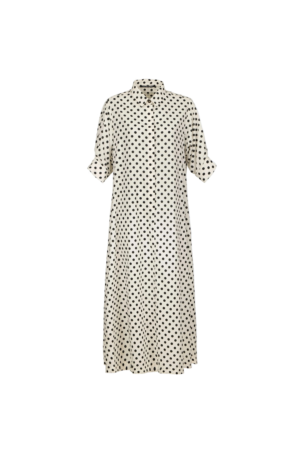 A cream-colored midi shirt dress with a black polka dot pattern, featuring short puff sleeves and a high collar, shown against a light blue-gray background.
bet28ter-k.4061
Hannes Roether