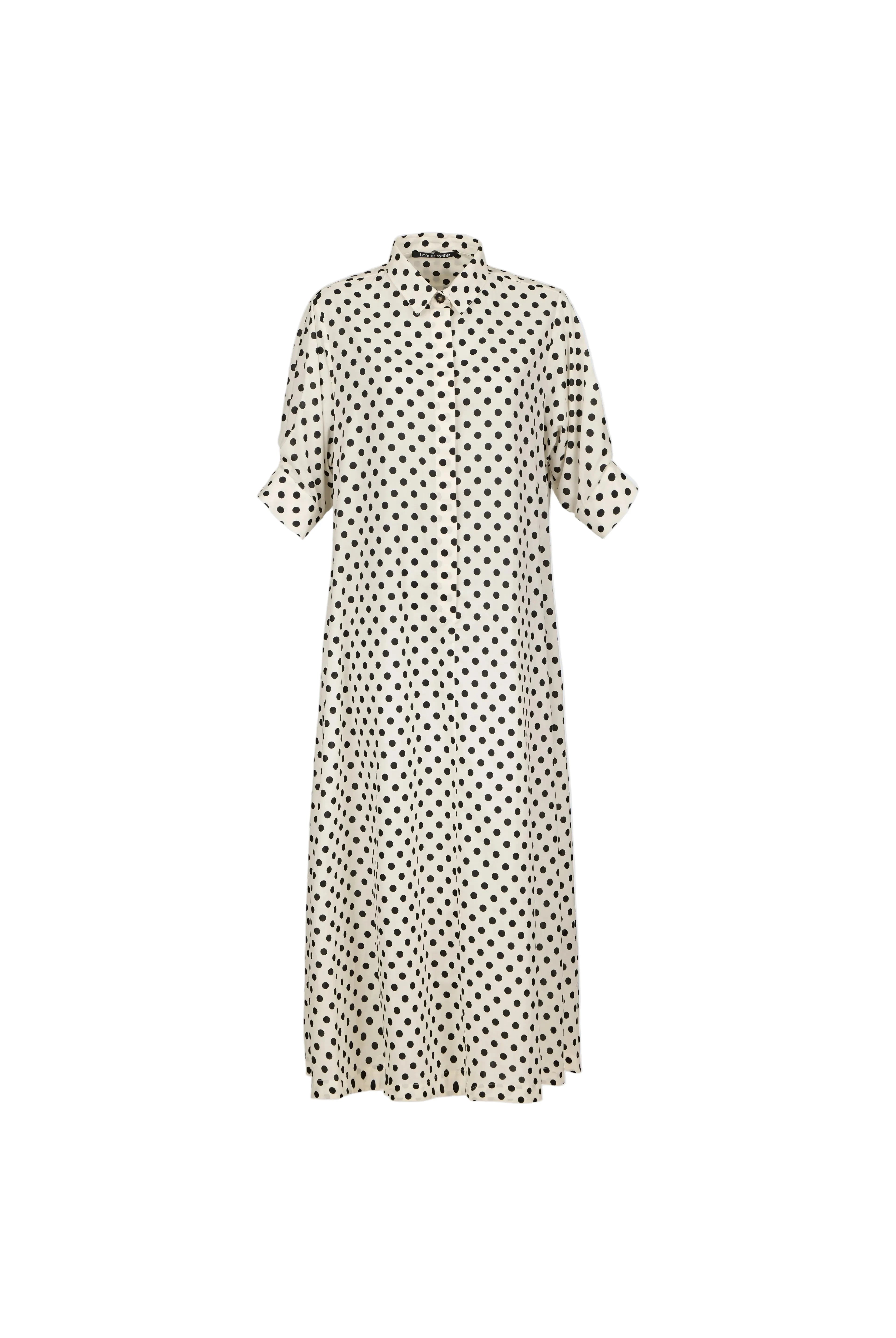 A cream-colored midi shirt dress with a black polka dot pattern, featuring short puff sleeves and a high collar, shown against a light blue-gray background.
bet28ter-k.4061
Hannes Roether