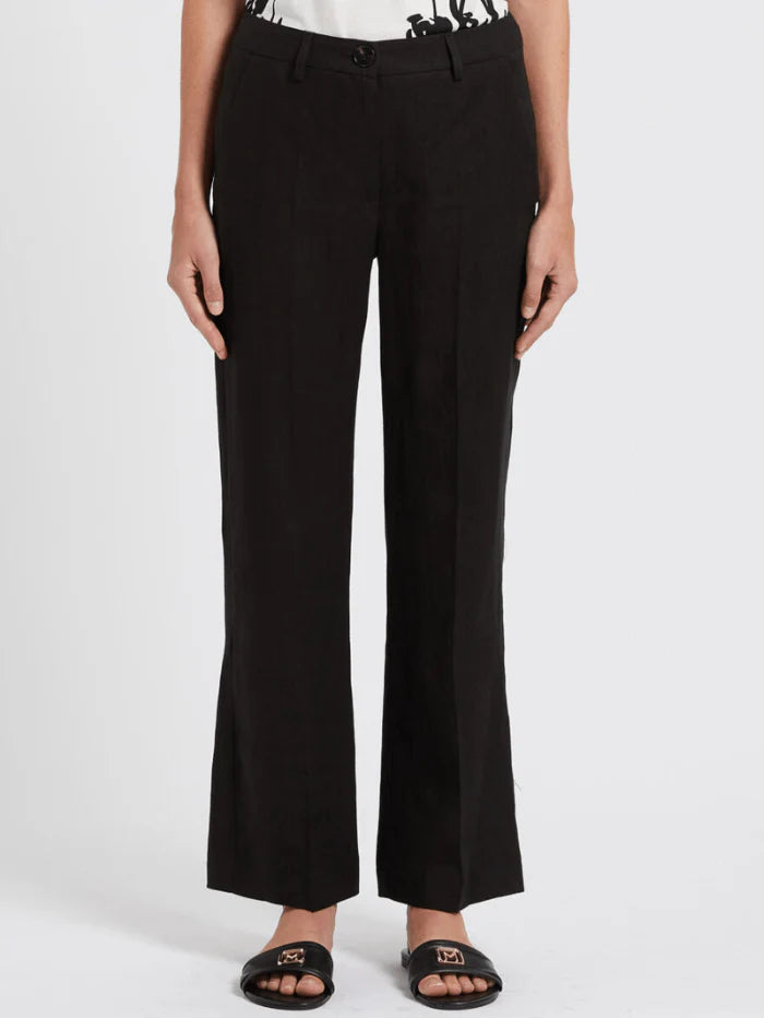 women standing in front of a white background wearing Marcella black trousers