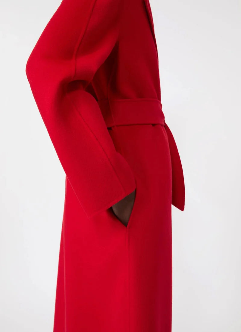 Red coat with a belt on a white background