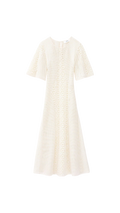 White dress with a subtle pattern on a white background