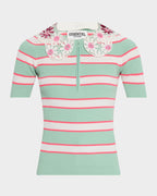 Green and pink striped shirt with floral collar on a white background