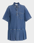Blue denim dress with pleated skirt on a light gray background