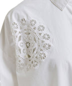 White blouse with intricate lace detailing on a white background