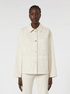 Person wearing a cream-colored jacket and pants on a white background