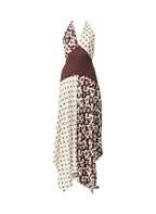 A halter-neck maxi dress with a patchwork design featuring cream and brown polka dot patterns and a solid dark brown textured panel, shown against a plain white background.